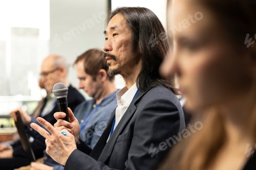 Preview: Asian male professional takes microphone to ask questions and engage in debate