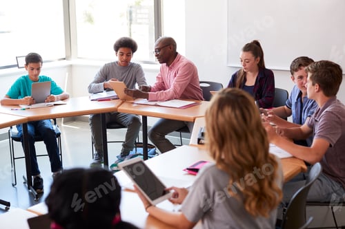 Preview: High School Teacher With Pupils Using Digital Tablets In Technology Class