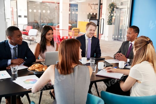 Preview: Business colleagues talking in a meeting room
