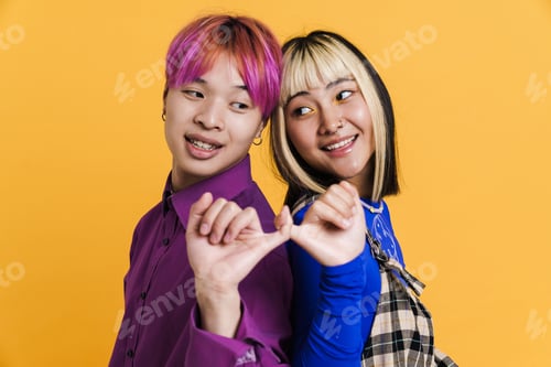 Preview: Asian couple holding little fingers of each other while smiling