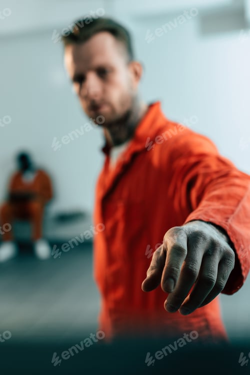 Preview: multiethnic prisoners in prison cell with hand on foreground
