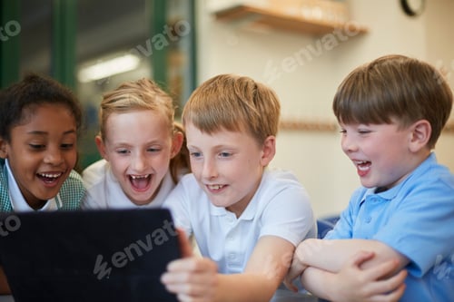 Preview: Group of joyful kids excitedly looking at a tablet screen together