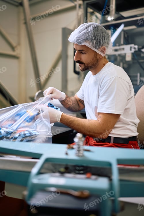 Preview: Assembly line worker working in a factory.
