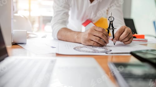 Preview: Male architect or engineer working for designing, drafting work plans and building house.