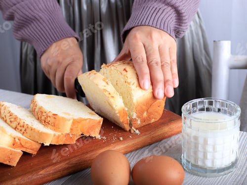 Preview: Female Home Chef Hand Cut Slicing Homemade White Japanese Brioche Loaf Bread