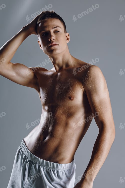 Preview: sporty man holding his hand on his head inflated body white shorts posing