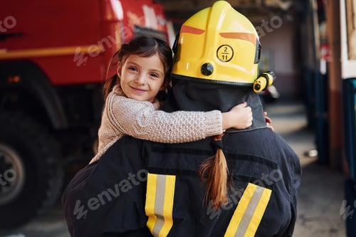 Preview: Happy little girl is with female firefighter in protective uniform