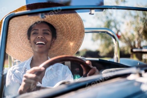Preview: Black woman driving a vintage convertible car