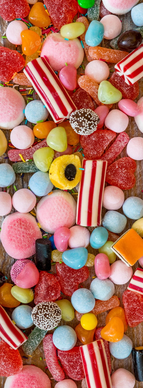 Preview: variety of candies on a wooden background