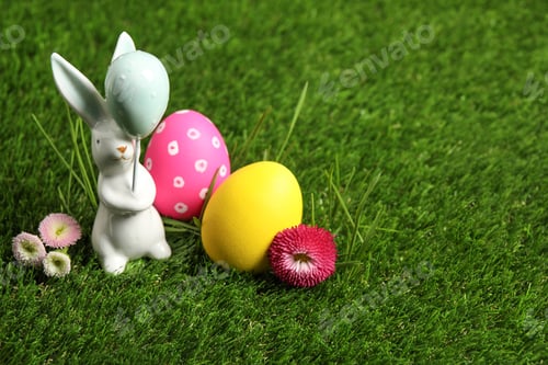 Preview: Colorful Easter eggs, rabbit and daisy flowers on green grass. Space for text