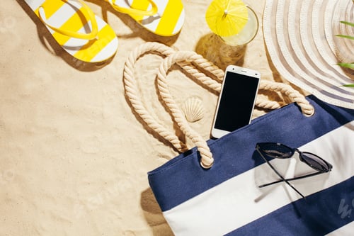 Preview: Beach blue bag, flip flops and cell phone on a beach.