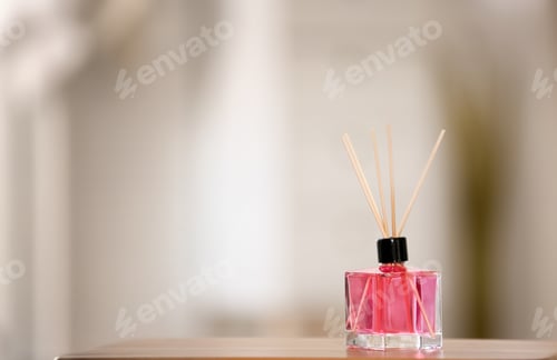 Preview: Aromatic reed air freshener on table against blurred background