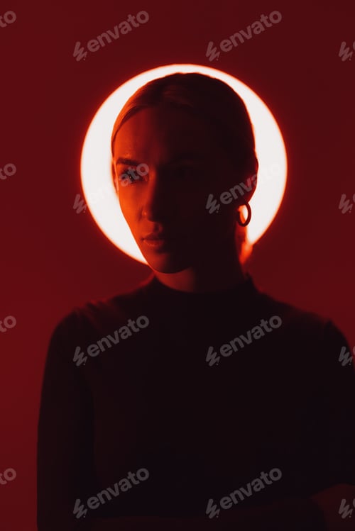 Preview: Woman in neon light against red backdrop