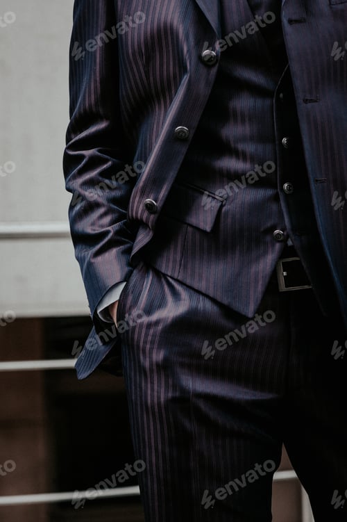 Preview: Businessman adult with hands in pockets of modern black tuxedo outdoor near office building
