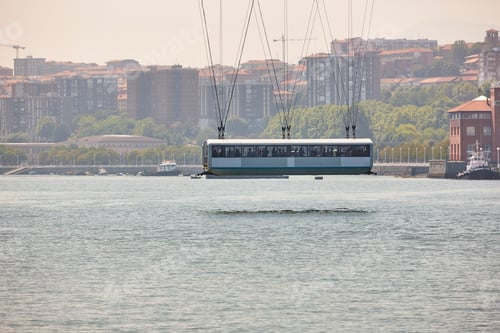 Preview: Bizkaia red iron hanging bridge gondola and Nervion river. Euskadi