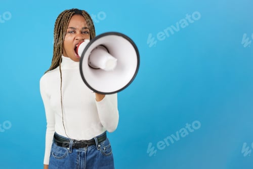 Preview: Angry african woman protesting while using a loudspeaker