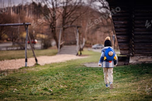 Preview: Child Running Through Park at Sunset