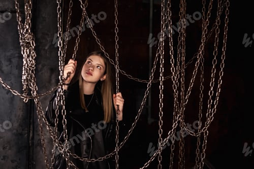 Preview: Portrait of teen girl model 12-13 year in leather jacket in dark industrial room