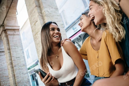 Preview: Three happy female friends having fun together outdoor