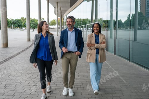Preview: Diverse business team walking smiling outside modern office