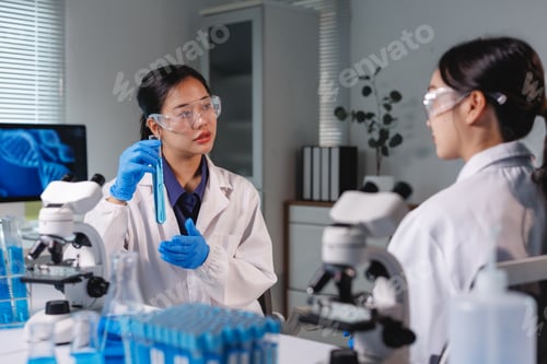Preview: Scientists discussing about test tube in laboratory