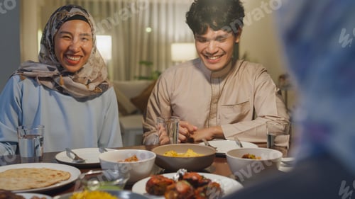 Preview: Close-up Happy Asia muslim wife talk to husband Ramadan dinner together at home.
