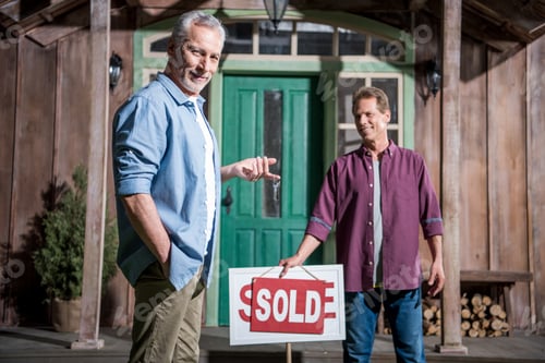 Preview: smiling senior man buying new house and holding keys