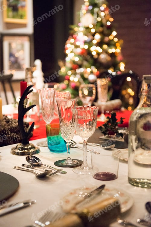 Preview: A table laid for a Christmas meal, with silver and crystal glasses