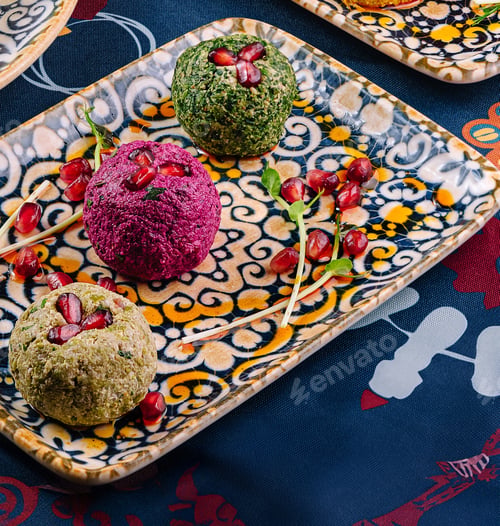 Preview: Georgian appetizer pkhali with pomegranate seeds on a colorful plate