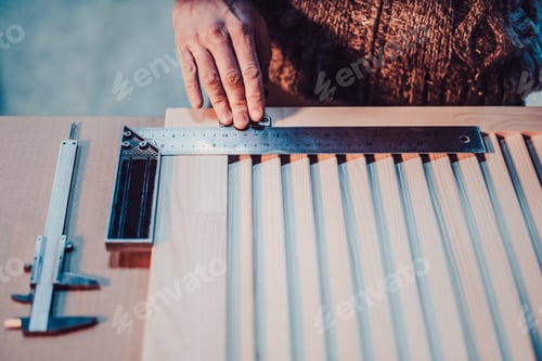 Preview: Woodwork And Furniture Making Concept. A Carpenter In The Workshop Marks Out And Installs The