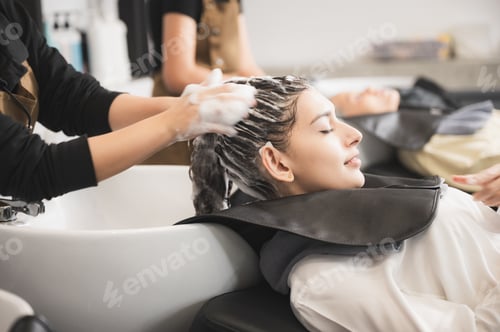 Preview: Woman Relaxing While Receiving Hair Wash at Salon