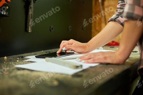 Preview: Female business owner using digital tablet in workshop