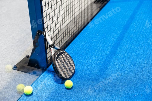 Preview: Paddle tennis racket, ball and net on the court