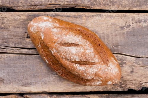 Preview: Freshly baked traditional bread on wooden background.