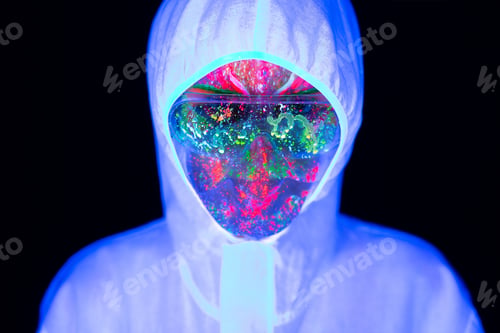 Preview: Doctor in ultraviolet neon light is holding COVID-19, coronavirus vaccine and syringe