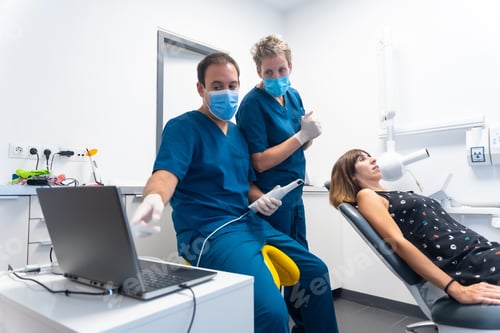 Preview: Dental clinic, dentist preparing the new scanner to make the 3d denture, explaining how it works