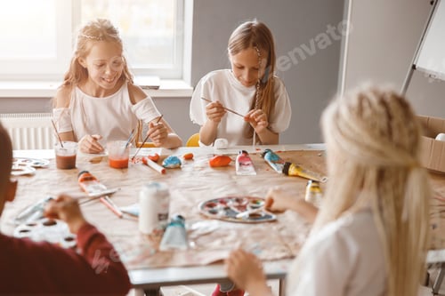 Preview: Happy children painting on paper with colorful paints in school