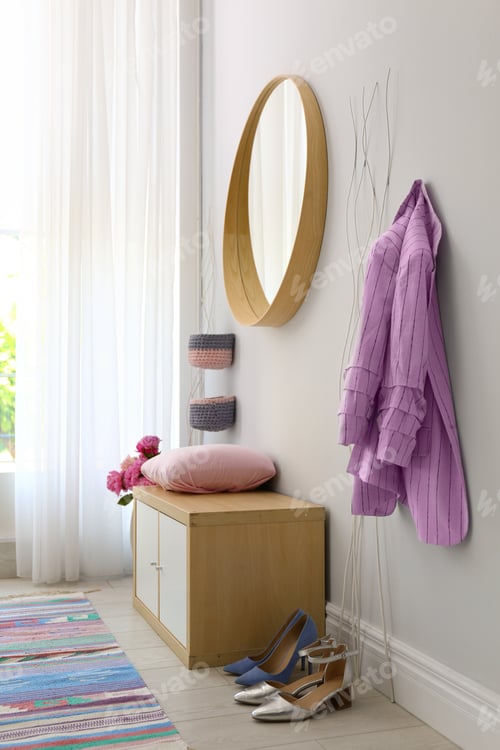Preview: Stylish hallway interior with round mirror on white wall