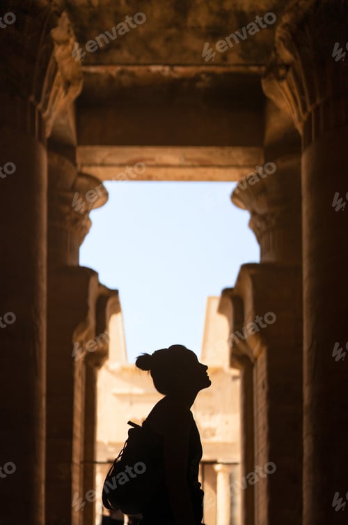 Preview: Silhouette of a woman gazing an Egyptian temple