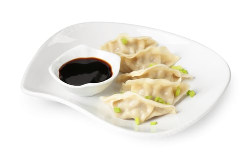 Preview: Tasty gyoza (dumplings) and soy sauce isolated on white