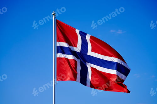 Preview: Norwegian flag flutters on a sunny day from a flagpole