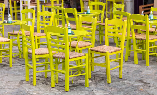 Preview: Cafe bar open air. Empty seats on cobblestone street background, Areopoli, Mani Greece