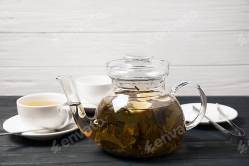 Preview: Teapot with hot aromatic tea on table