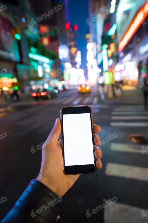Preview: hand holding phone at night in the city