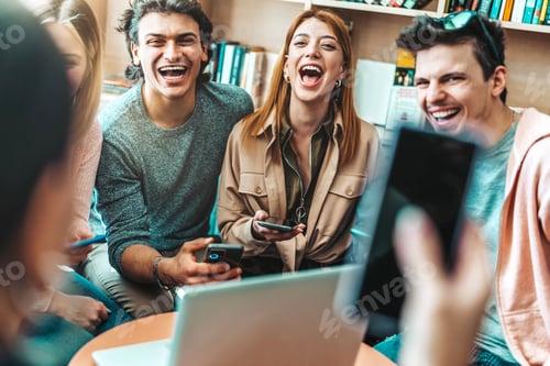 Preview: University students sitting at table with books and laptop