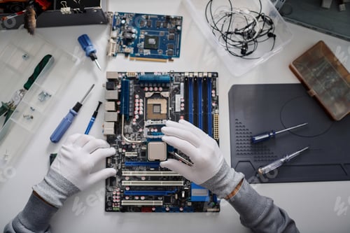 Preview: Electronic Repairman Working on CPU Installation Into Computer