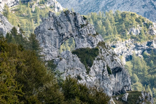 Preview: Scenic rock arch surrounded by lush greenery