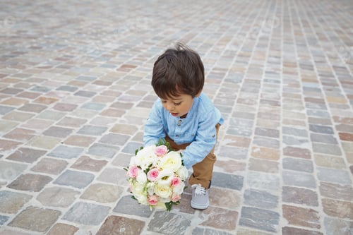 Preview: Cute little boy holding a bouquet of flowers