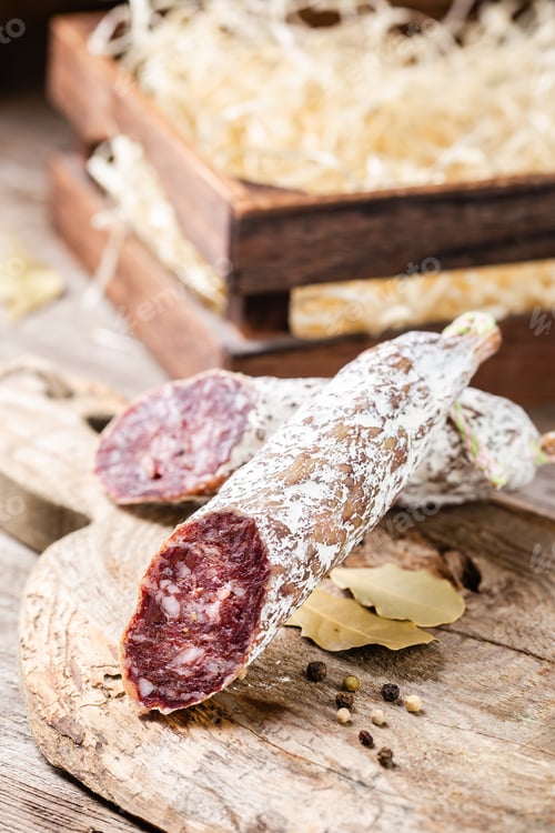 Preview: Smoked sliced salami on a old wooden table