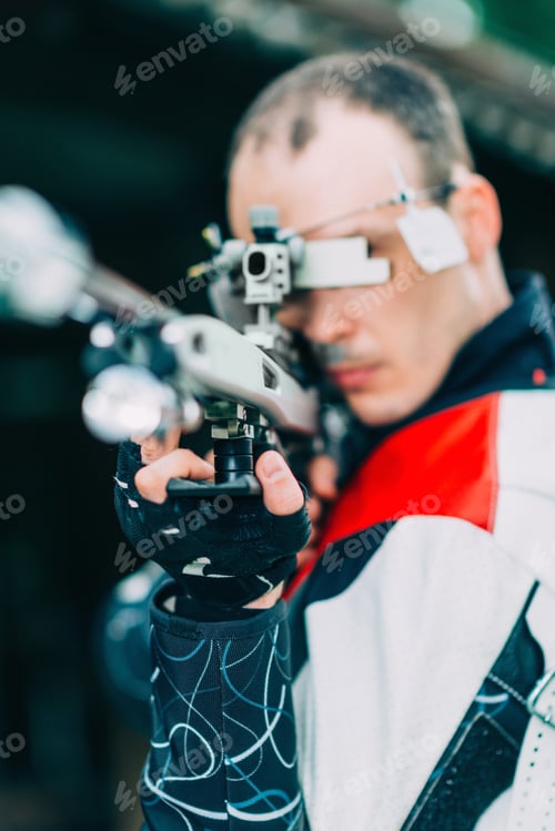 Preview: Man practicing for competition sport shooting with free rifle